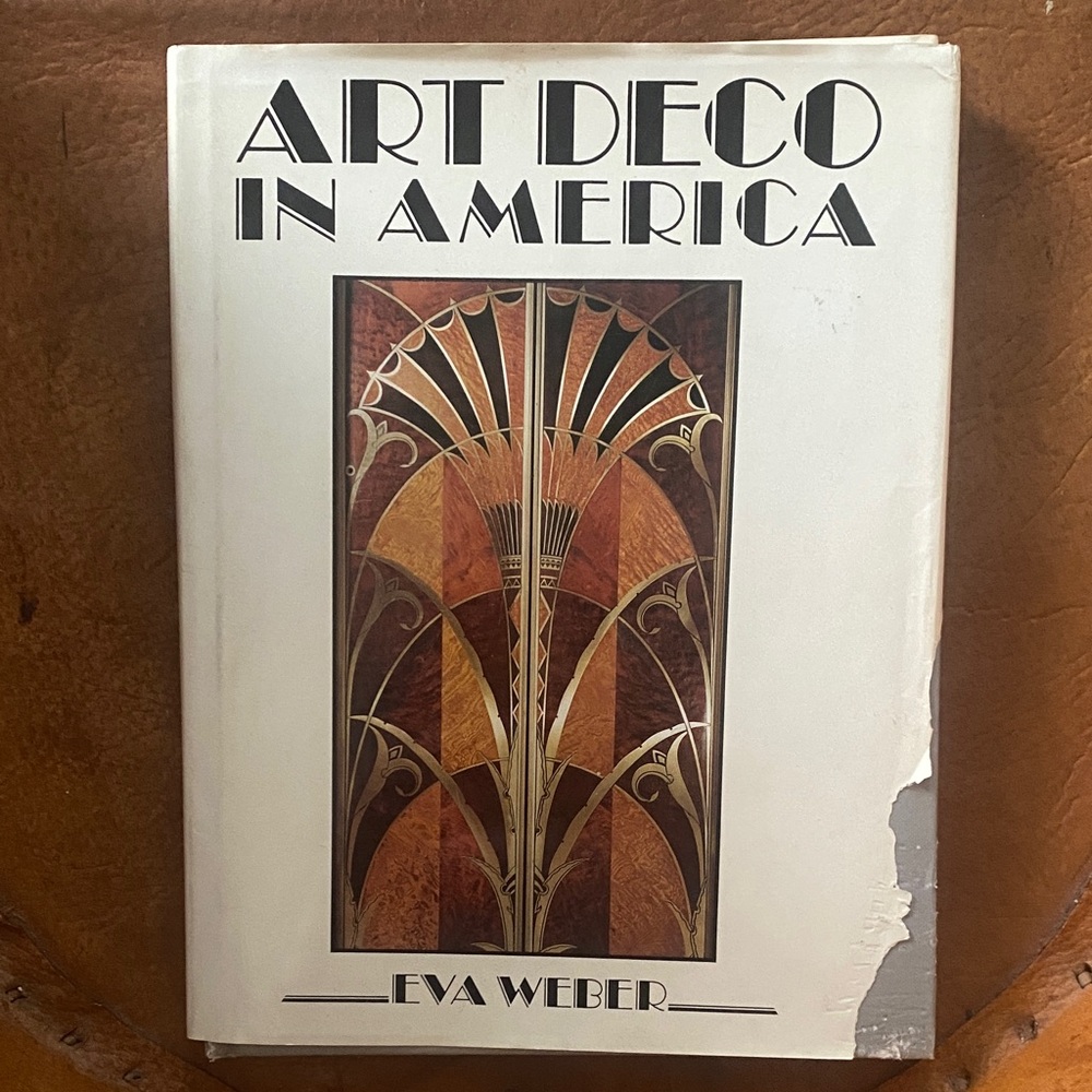 A book titled "Art Deco in America" by Eva Weber.